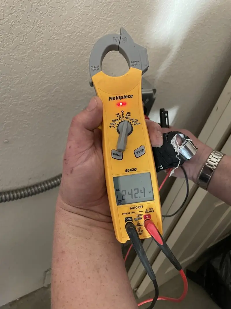 Voltage testing with clamp meter during Ceiling Fan Installation in Ozark